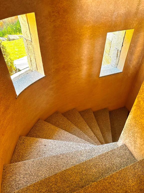 a view of a staircase with two pictures on the wall at Résidence Aigue Marine in Coti-Chiavari