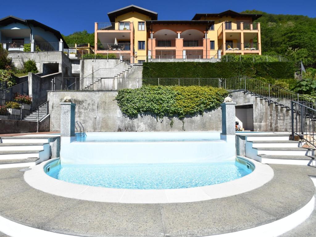 a swimming pool in front of a house at Apartment by Lake Maggiore with Stunning View in Oggebbio