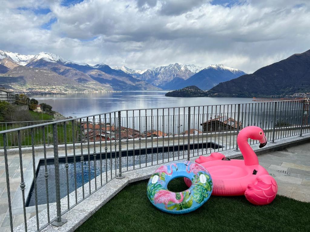 a pink swan and a donut sitting on a balcony at VILLA DEI VENTI NORTH by Curtiaffitti in Pianello Del Lario