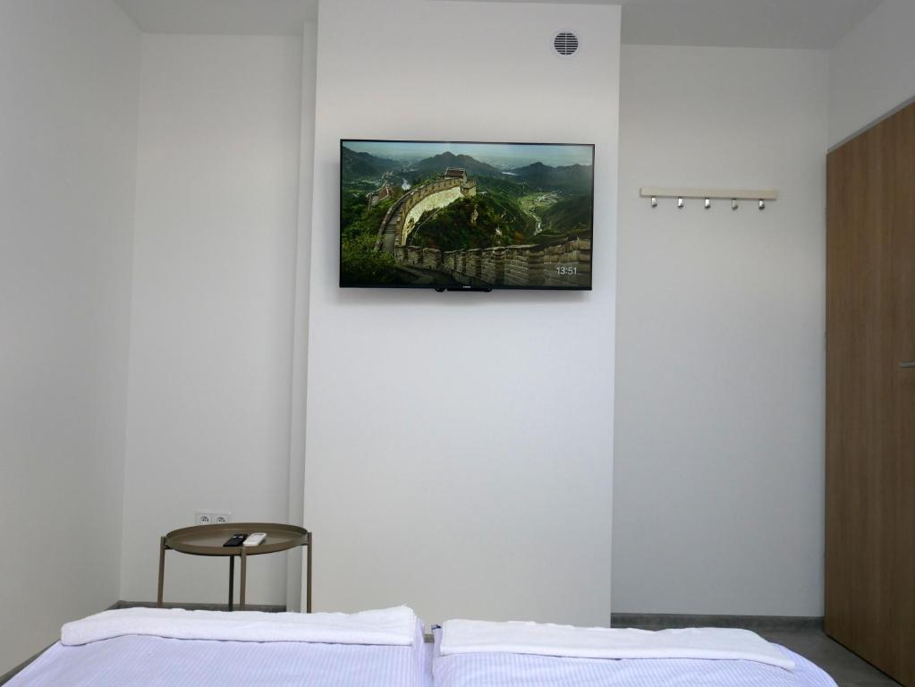 a bedroom with a picture of a bridge on the wall at Alda in Pyrzowice