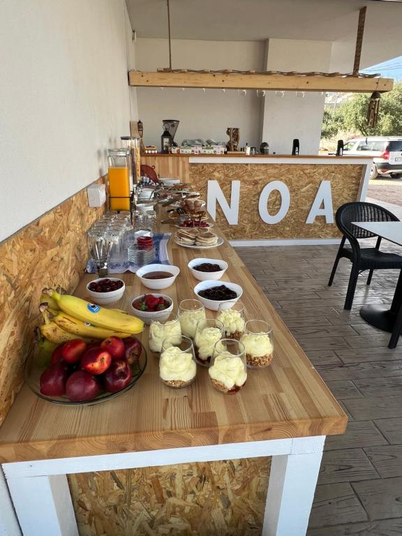 a table with a bunch of food on it at Noa Boutique Hotel in Ksamil