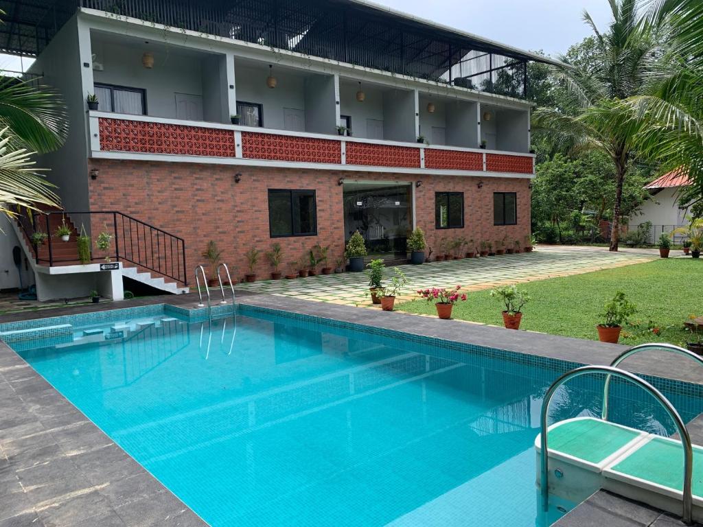 The swimming pool at or close to SAMRUDHI ORGANIC FARMSTAY