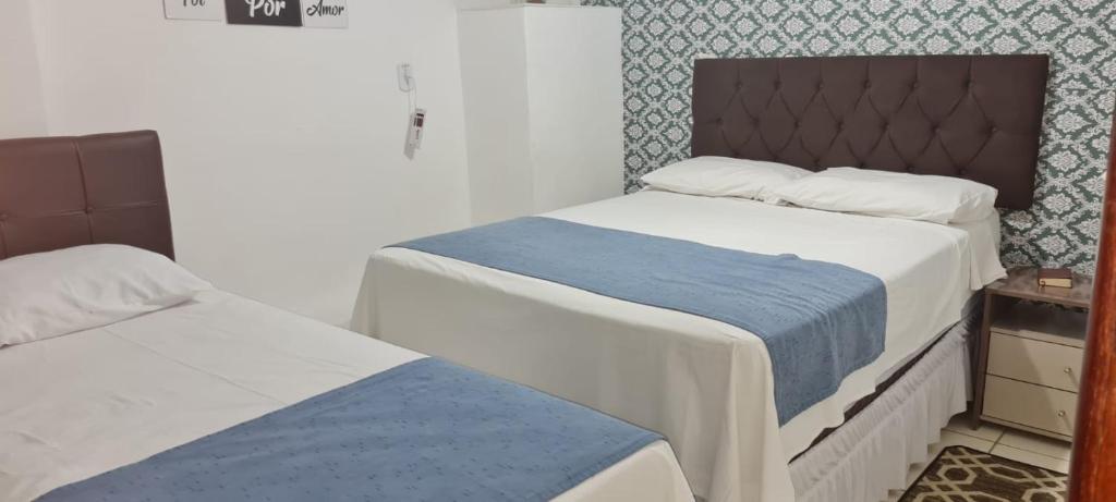 a bedroom with two beds and a bedskirts at Apartamento encantador 3 in Montes Claros