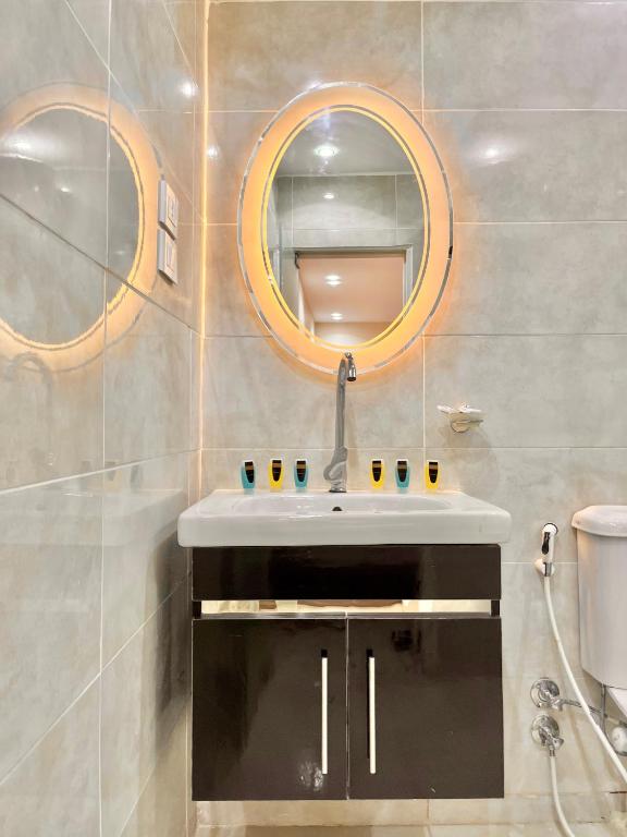 a bathroom with a sink and a mirror at Dima Pyramids View in Cairo