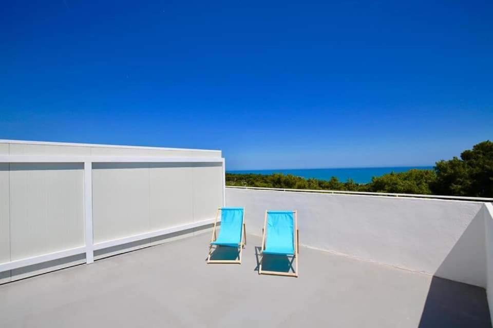 two blue chairs sitting on top of a roof at ML Apartments in Vieste