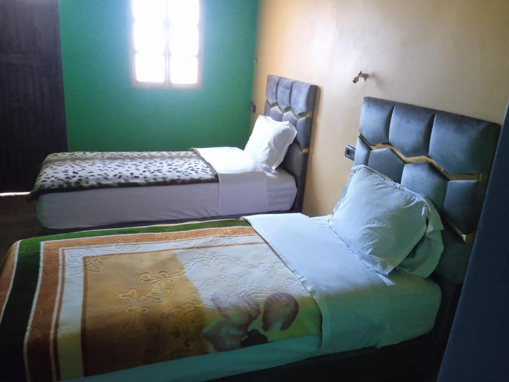 Postel nebo postele na pokoji v ubytování Riad atlas imnane