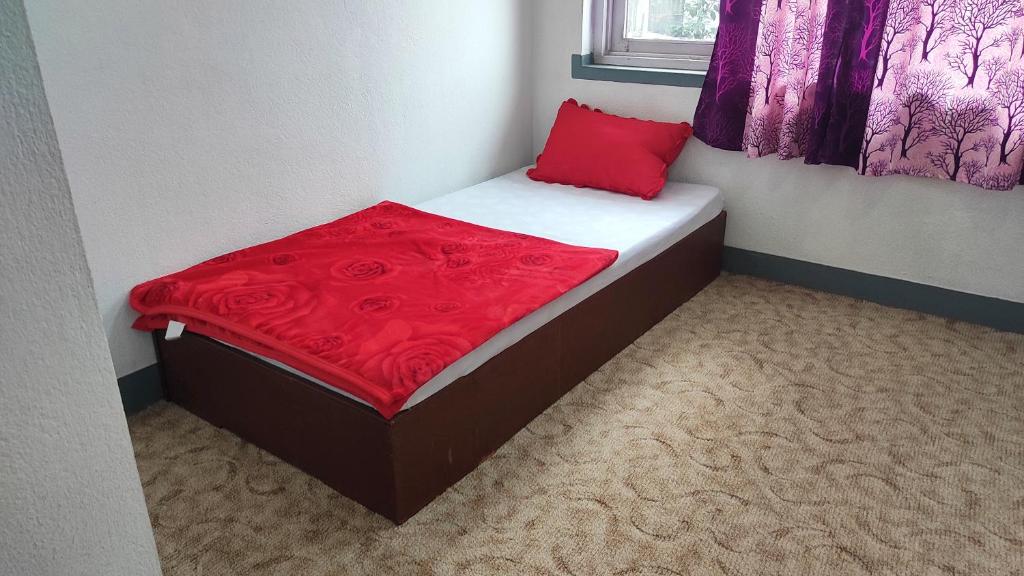 Ένα ή περισσότερα κρεβάτια σε δωμάτιο στο Budget Backpacker's Hostel