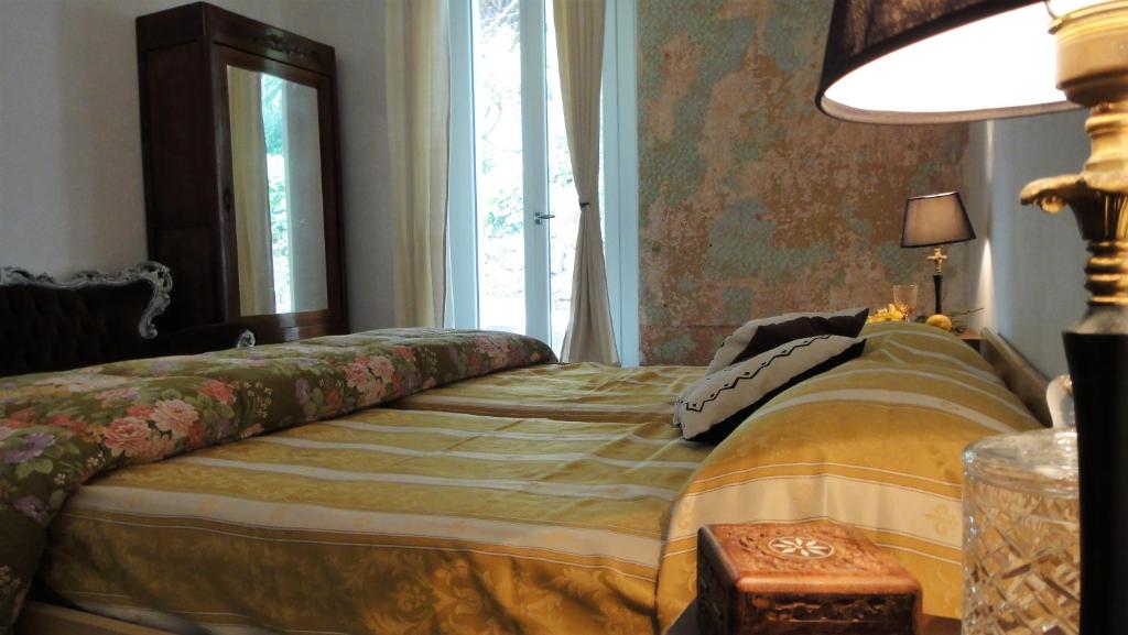 a bed sitting in a room with a window at Villa Vento Largo, Casa Irene in Ventimiglia