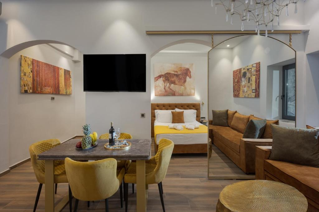 een woonkamer met een tafel en een bank bij Royal Gold City Suites by Estia in Heraklion