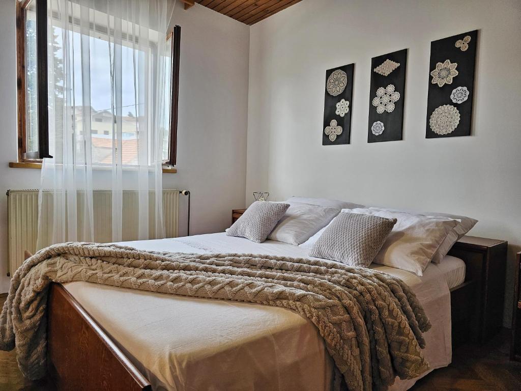 a bedroom with a bed with a blanket on it at Vetus pontem in Vrboska