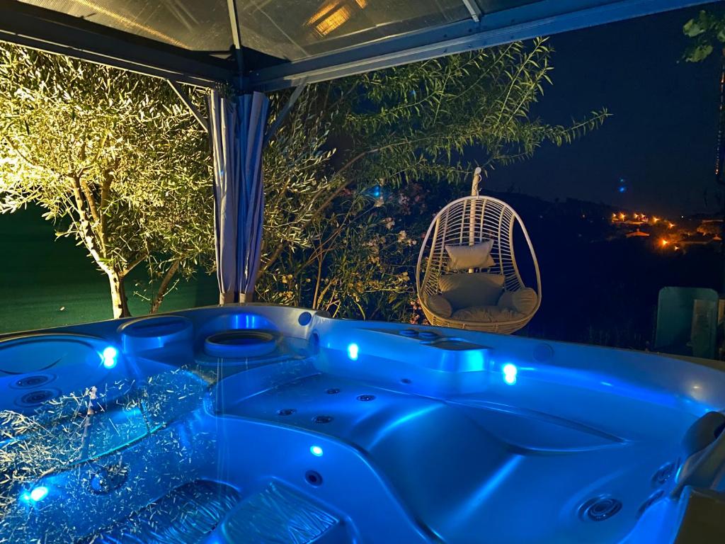 a blue tub sitting in front of a window at T&A Lodge AVEC SPA JACUZZI à 11km de la plage in Solliès-Pont