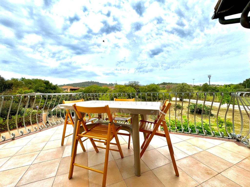 a table and chairs on a patio with a view at Casetta Al Mare in Àrbatax