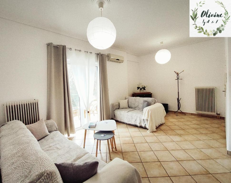 a living room with a couch and a bed at Olivóne apt, by A & F in Igoumenitsa