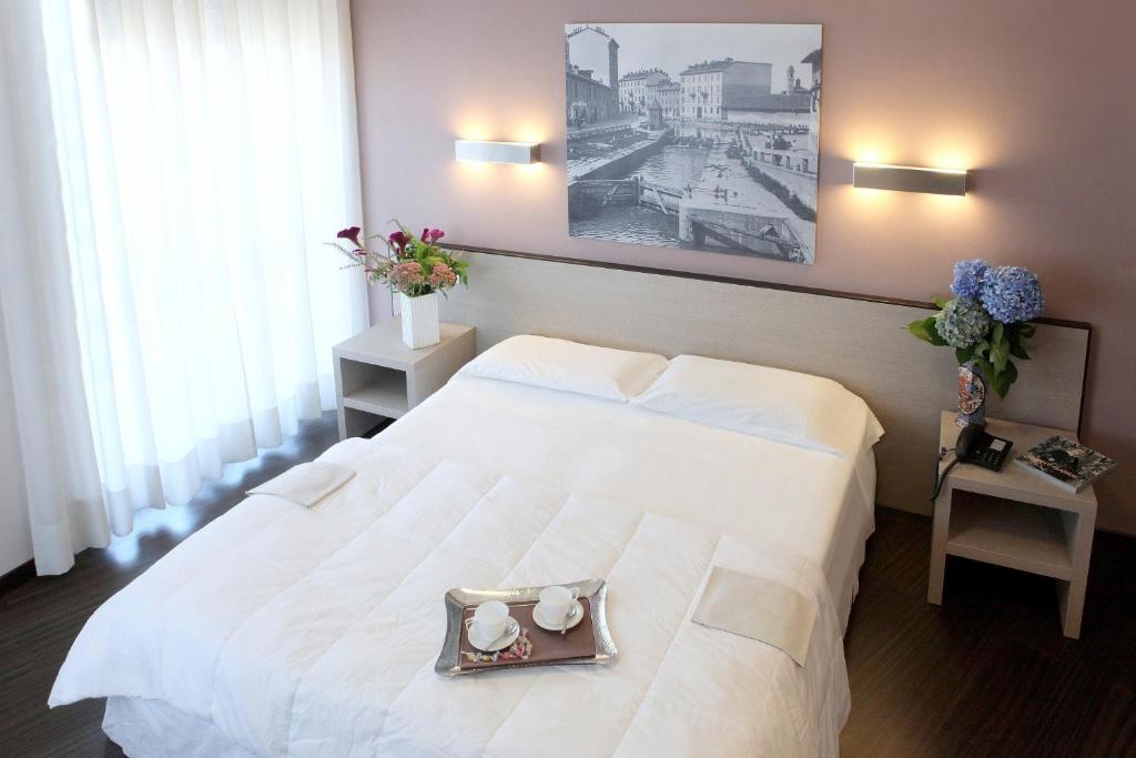 Postel nebo postele na pokoji v ubytování Hotel Mennini