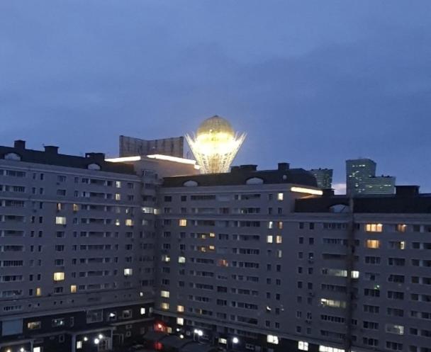 ein großes Gebäude mit einer Lampe darüber in der Unterkunft 25 Вид на Байтерек для 1-4 человек с кроватью и раскладным диваном in Astana