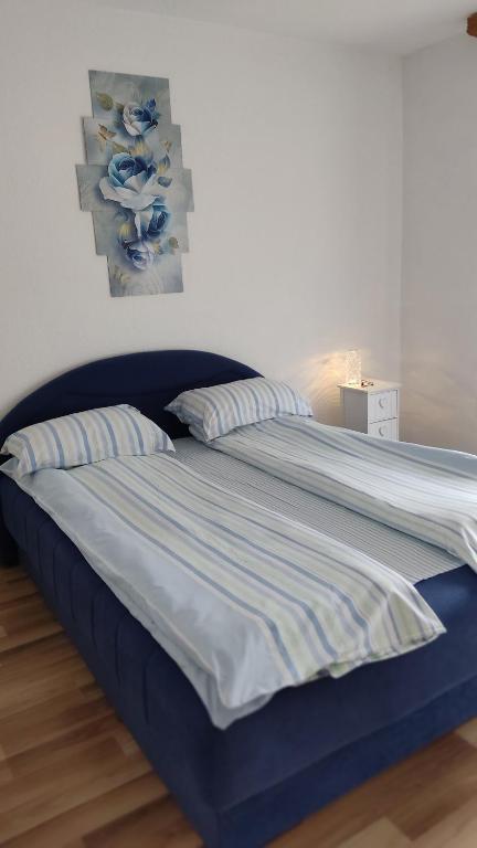 een blauw bed met 2 kussens in een slaapkamer bij Holiday home Dream Bosanska Krupa in Bosanska Krupa