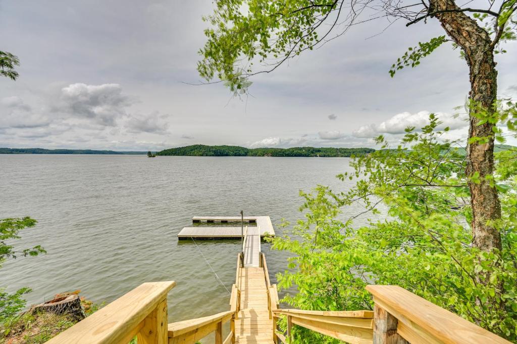 a dock in the middle of a lake at Fox Berry Hill - Lakefront with Dock, Launch & Hot Tub in Waverly