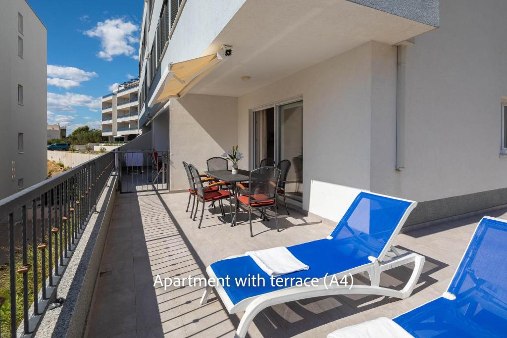 a balcony with chairs and a table on a building at La Mer Adriatique in Makarska