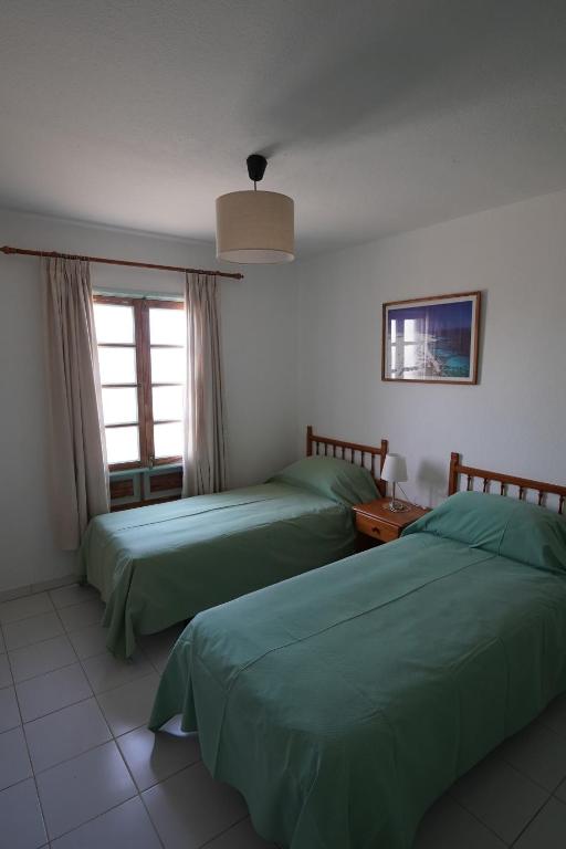 Postel nebo postele na pokoji v ubytování El Caleton Garden Apartment