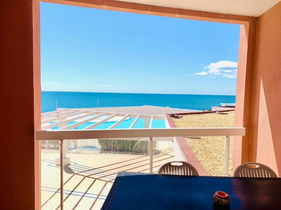 a room with a view of the ocean from a balcony at 557 Cap Corniche Front de mer Clim Parking in Sète