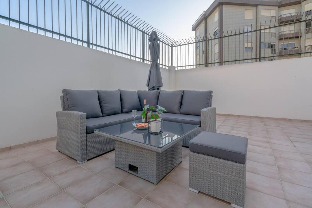 a couch and a table on a patio at Terrace Beach Apartment in Buarcos