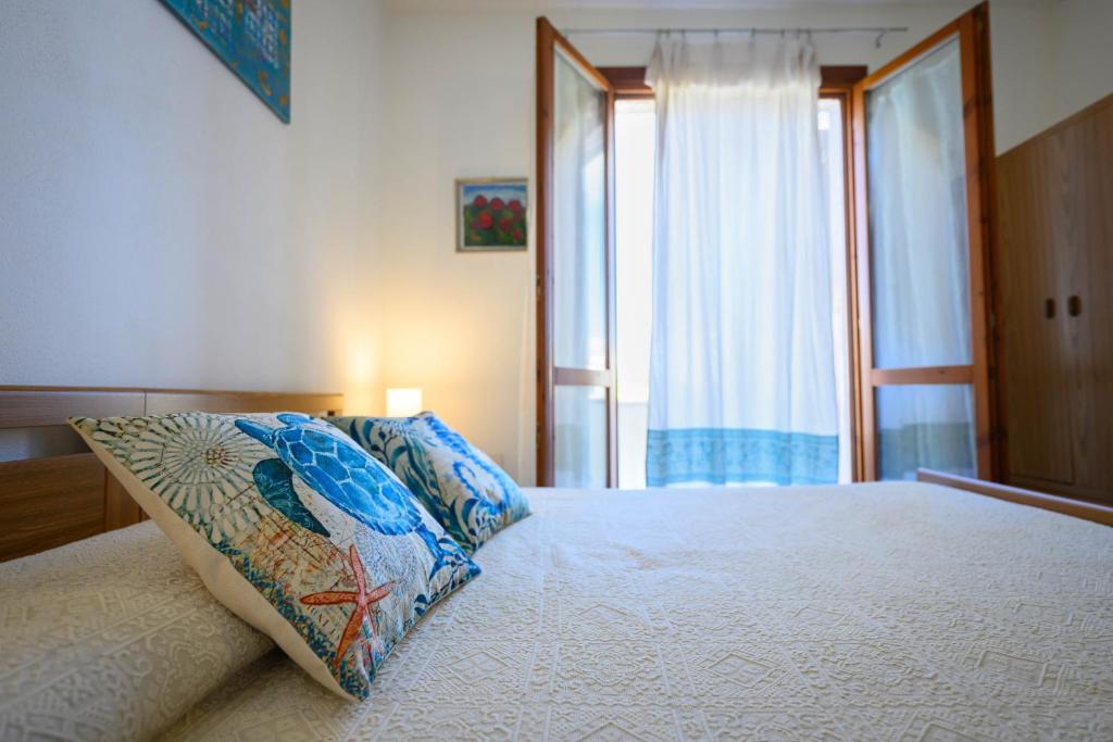 Ένα ή περισσότερα κρεβάτια σε δωμάτιο στο Residenza Grecale villetta con veranda vicino al paese