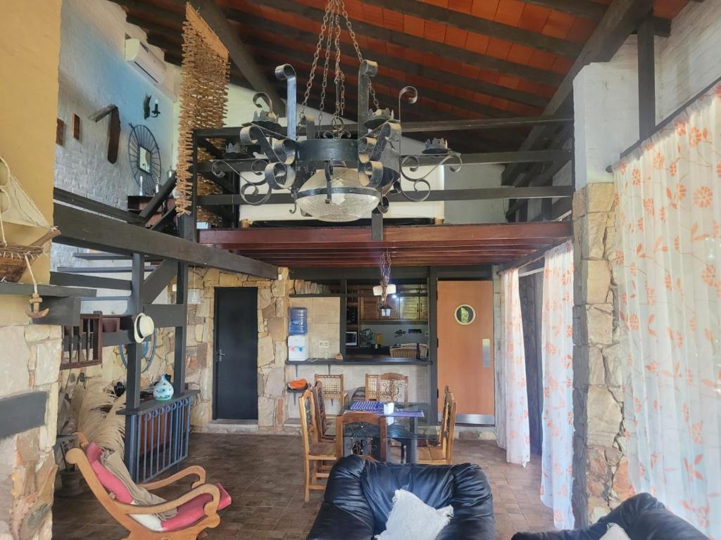 a living room with a table and a chandelier at La Soñada San Bernardino in San Bernardino
