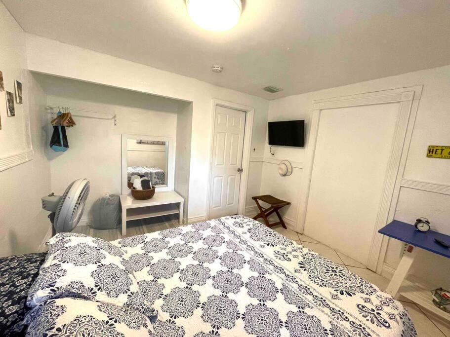 a bedroom with a bed with a blue and white comforter at Cozy Room in the Heart of Little Havana -3V in Miami