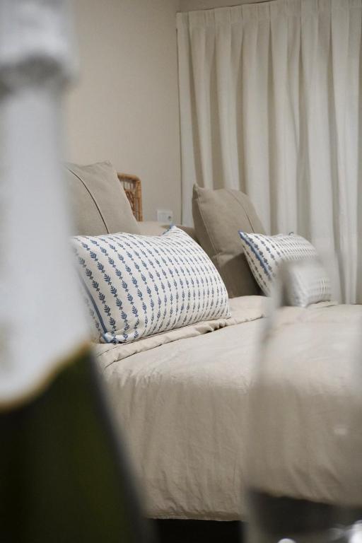 a close up of a bed with pillows on it at Estudio Veintisiete in Morón de la Frontera