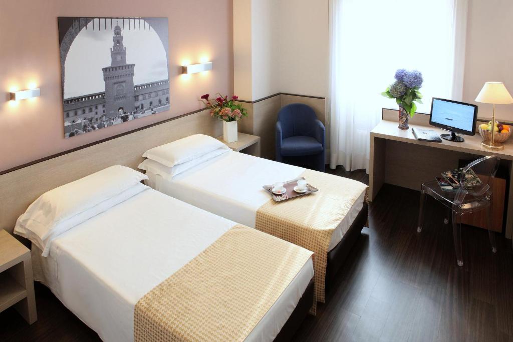 Postel nebo postele na pokoji v ubytování Hotel Mennini