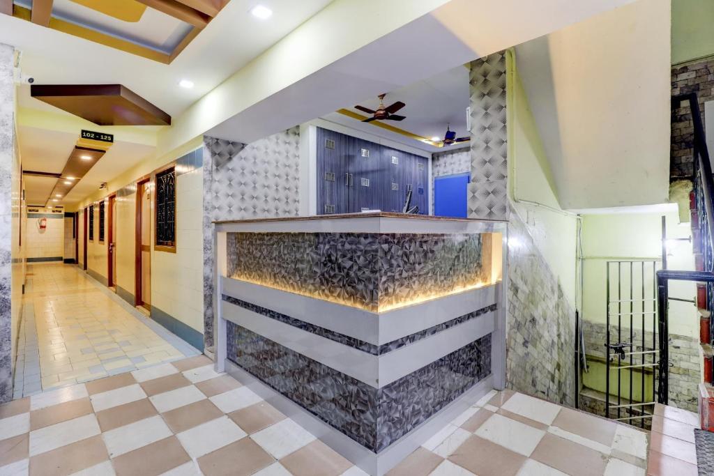 a lobby of a building with a stone wall at OYO Sam Guest House in Chennai