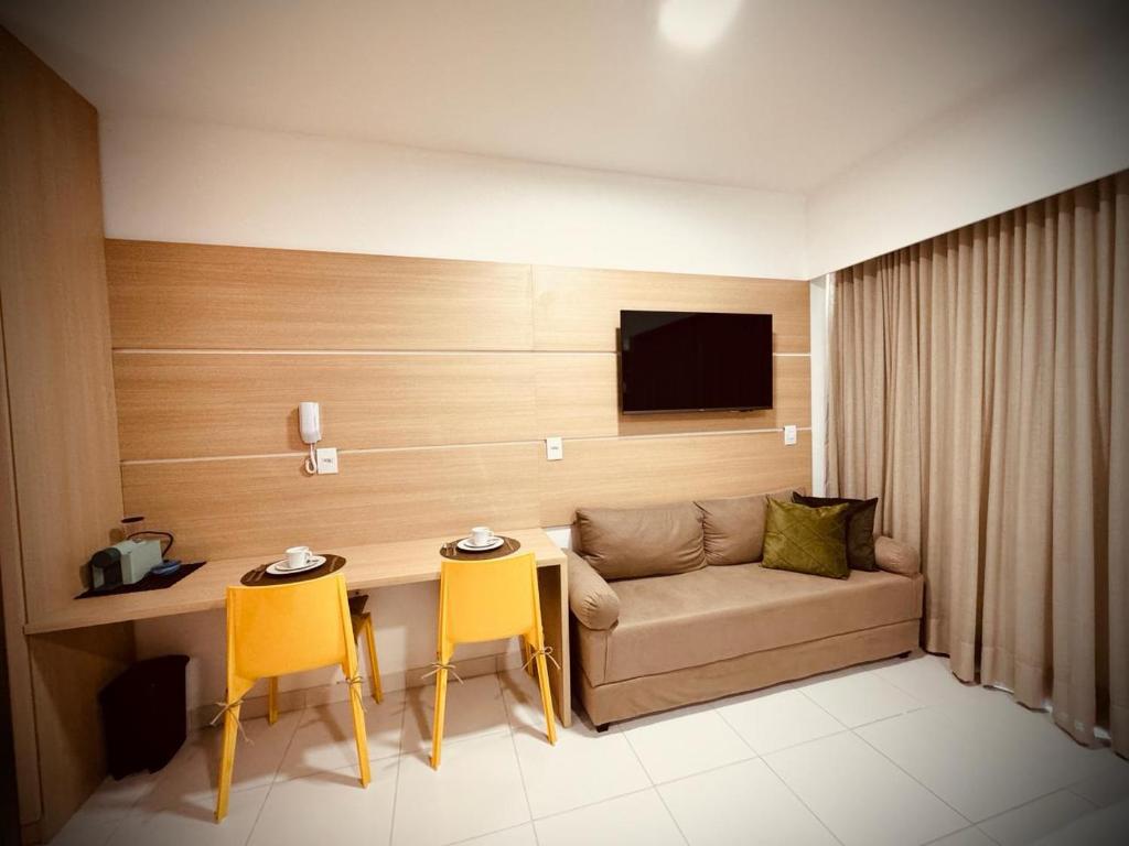 a living room with a couch and a table and chairs at MAKIA Beach Experience in Ipojuca