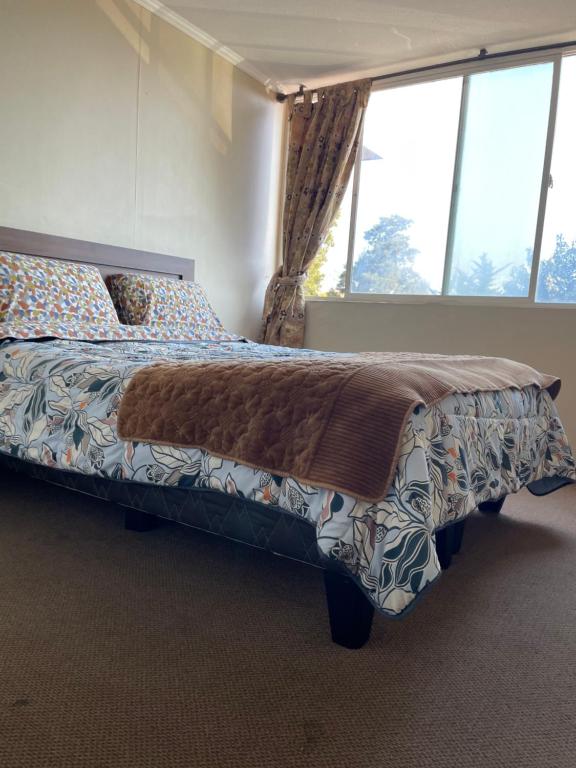 Кровать или кровати в номере Edificio Arauco
