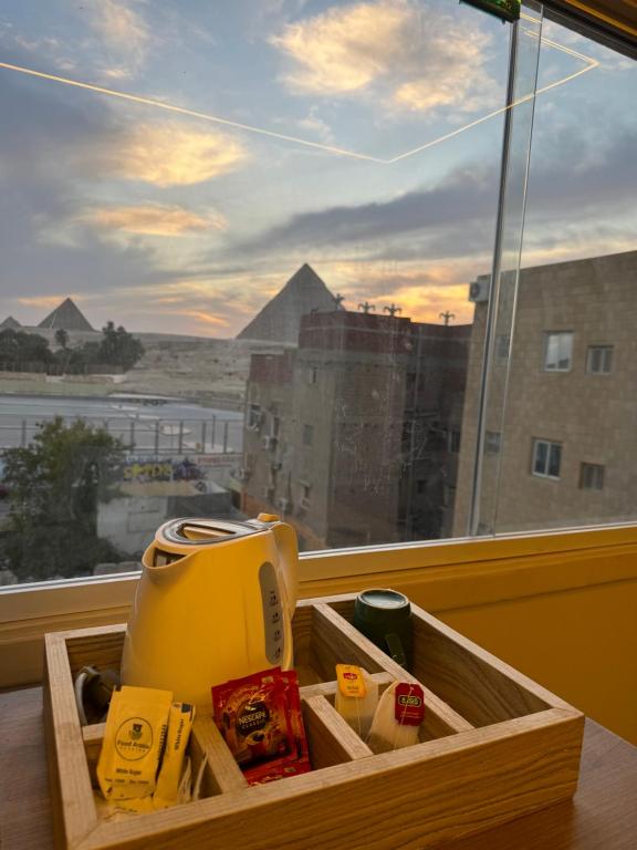 a blender in a wooden box in front of a window at Dima Pyramids View in Cairo