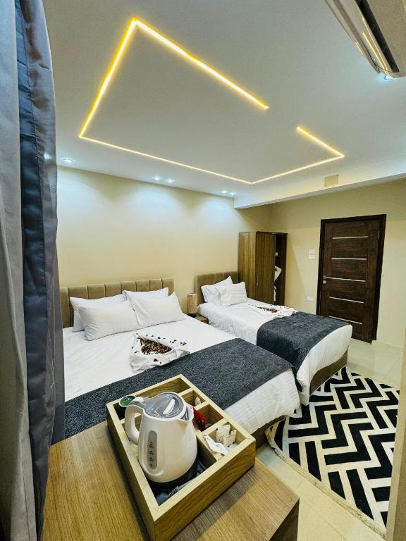 a hotel room with two beds and a tray of dishes at Dima Pyramids View in Cairo
