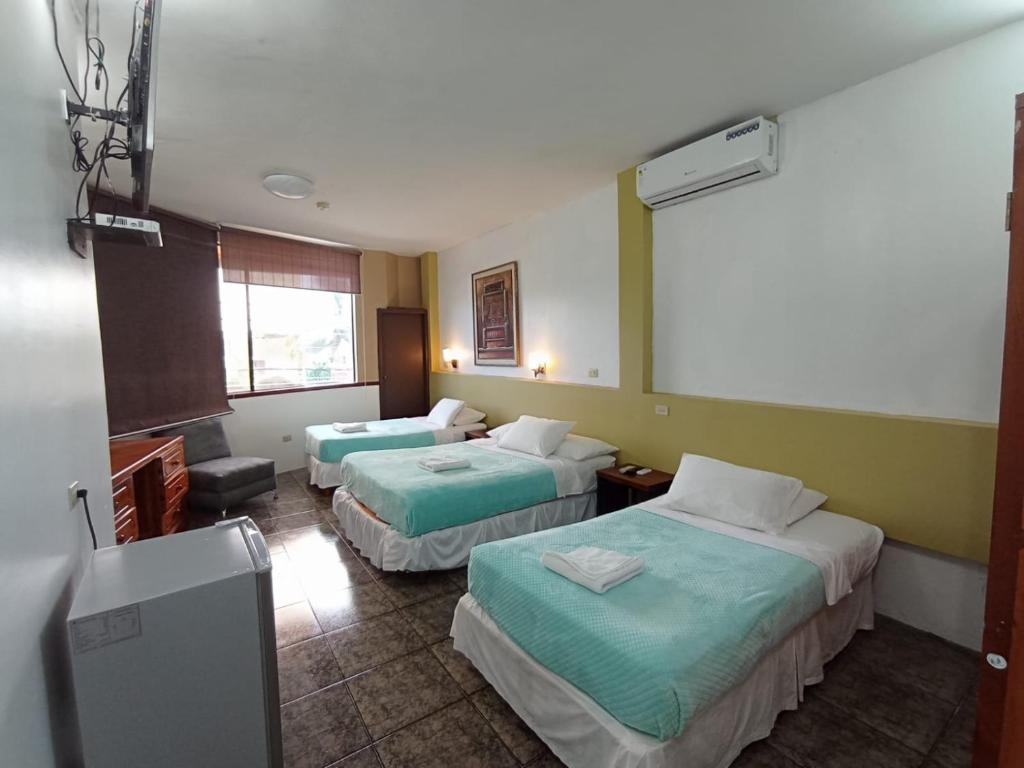 Postel nebo postele na pokoji v ubytování Hotel Los Algarrobos