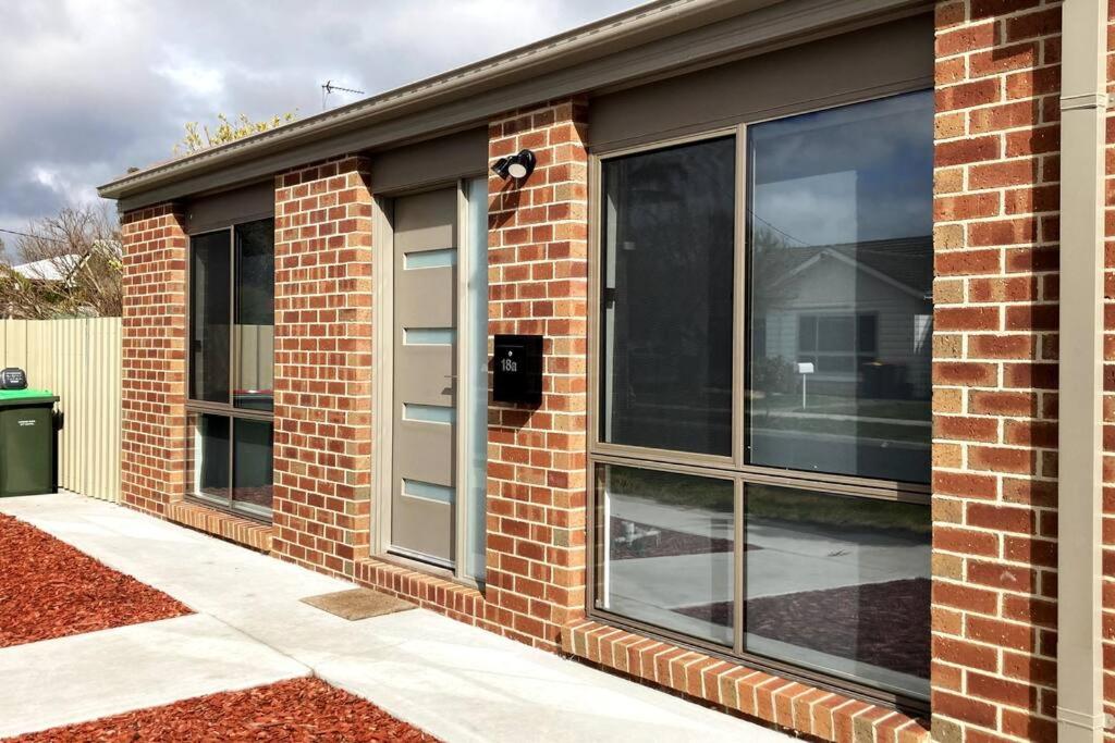 a brick building with windows on the side of it at Riverbank in Horsham