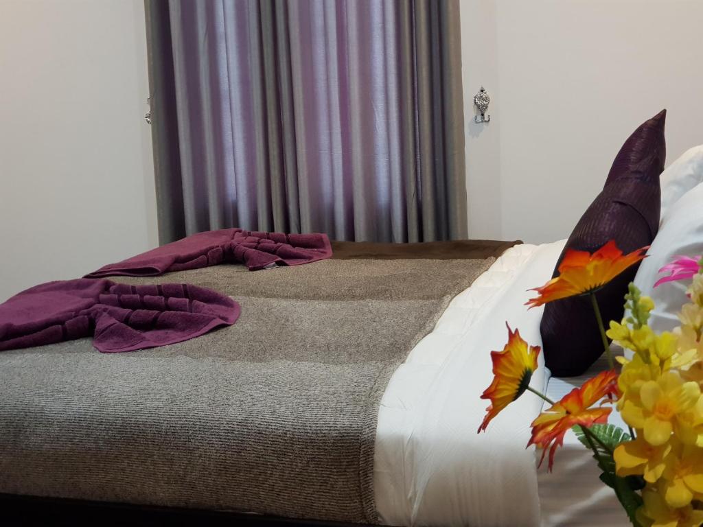 Postel nebo postele na pokoji v ubytování Taj Residence