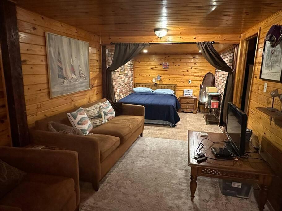 a living room with a bed and a couch at The Beach Cave in Santa Rosa Beach