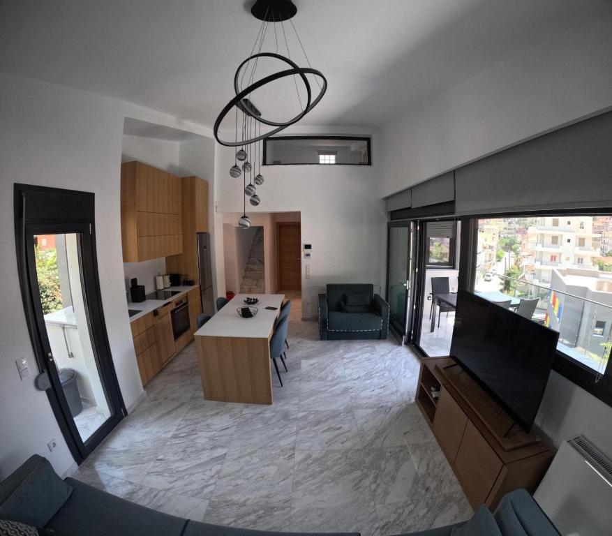 a large kitchen and living room with a table at Casa Bianca in Kavala