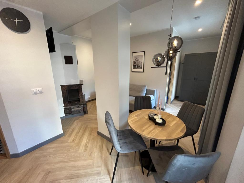 a dining room and living room with a table and chairs at Jon´s 2 Apartments in Pärnu