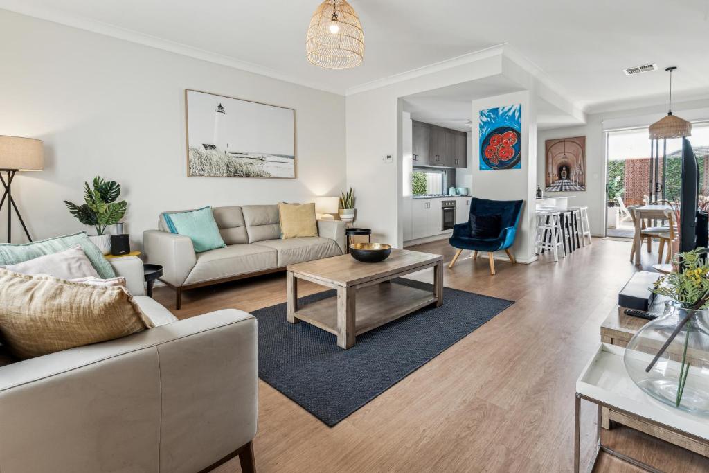 a living room with a couch and a table at West Croydon Condo in Woodville