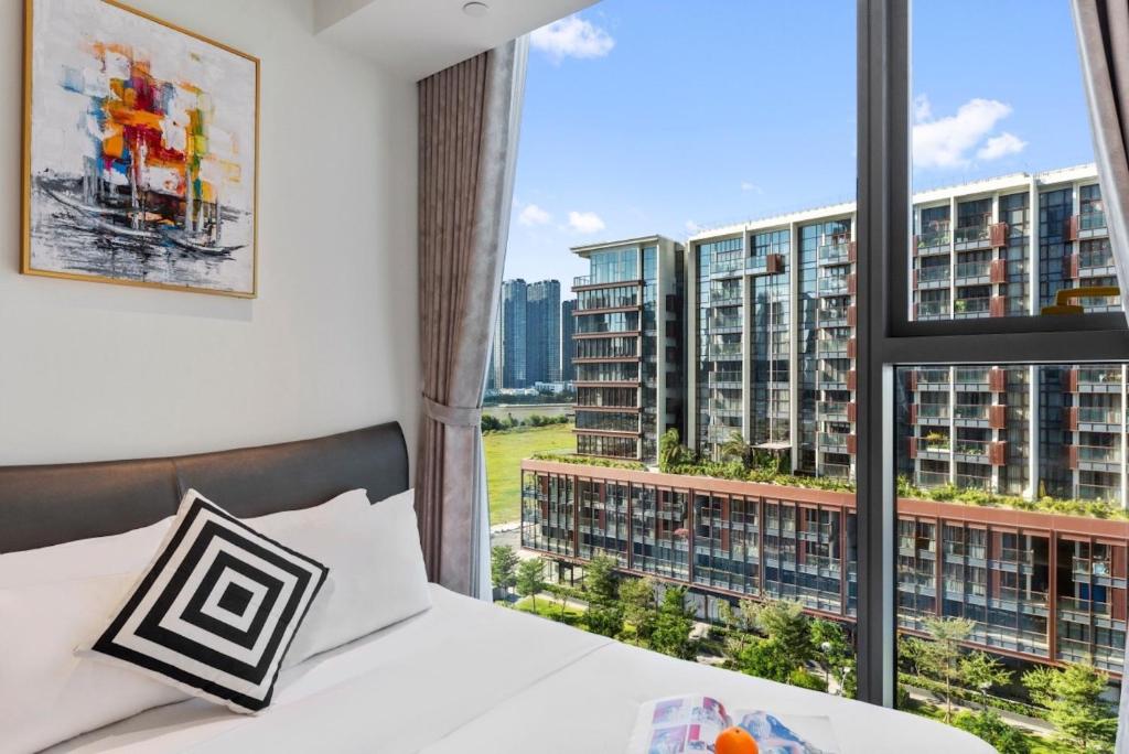 a bedroom with a bed and a large window at The Artistry Apartment Cental Saigon Heart Center in Ho Chi Minh City