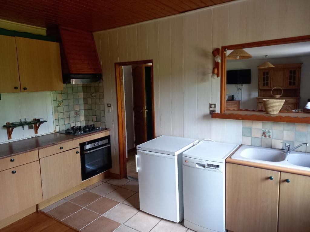 a kitchen with a white dishwasher and a sink at Bellavie2 in La Bresse