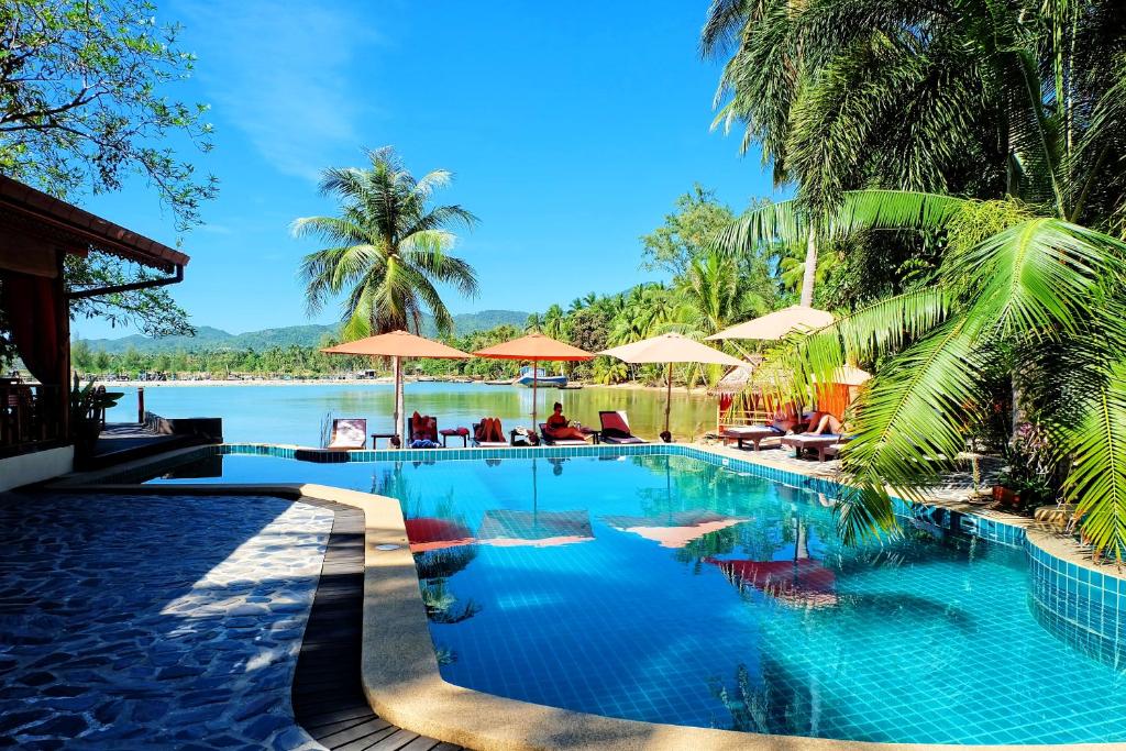 a swimming pool with a view of a body of water at Cyana Resort in Wok Tum