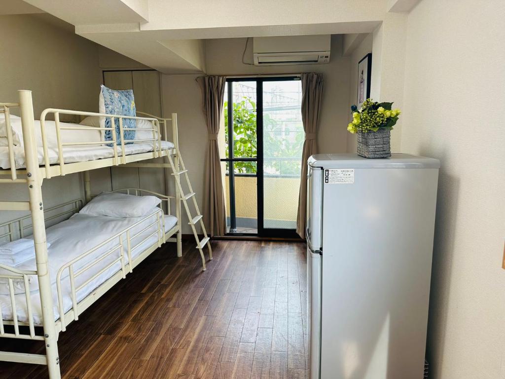 Una cama o camas en una habitación de 匯金北池袋ビル