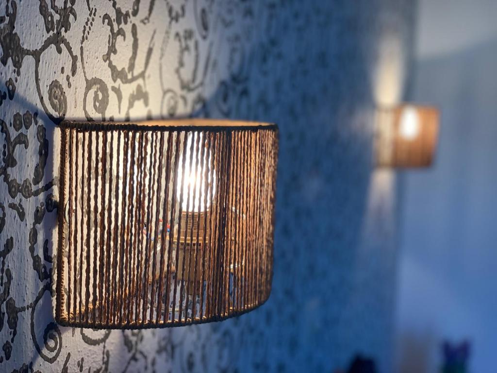 a close up of a lamp on a wall at Skopelos Inn in Stafylos
