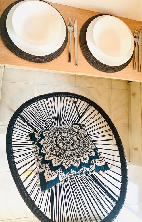 two plates on a wooden shelf with utensils at Skopelos Inn in Stafylos