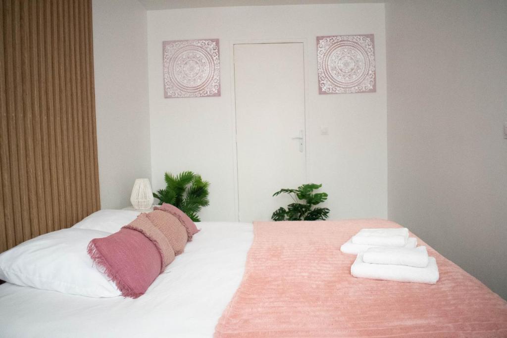 um quarto com uma cama com toalhas em Le Cosy - Centre Ville - 2 pièces em Beauvais