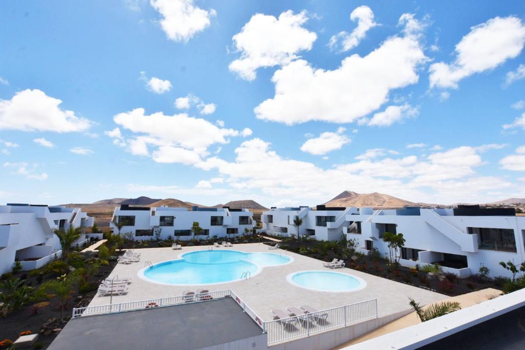 a view of a resort with two swimming pools at Book Jet - Casilla de Costa Dreams in Villaverde